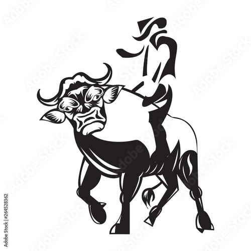 Rodeo cowboy riding a wild bull