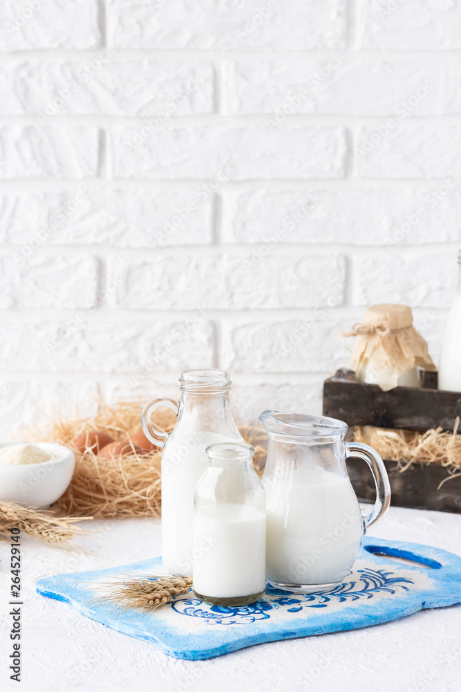 Milk in bottles of various shapes and sizes Milk in bottles of various shapes and sizes