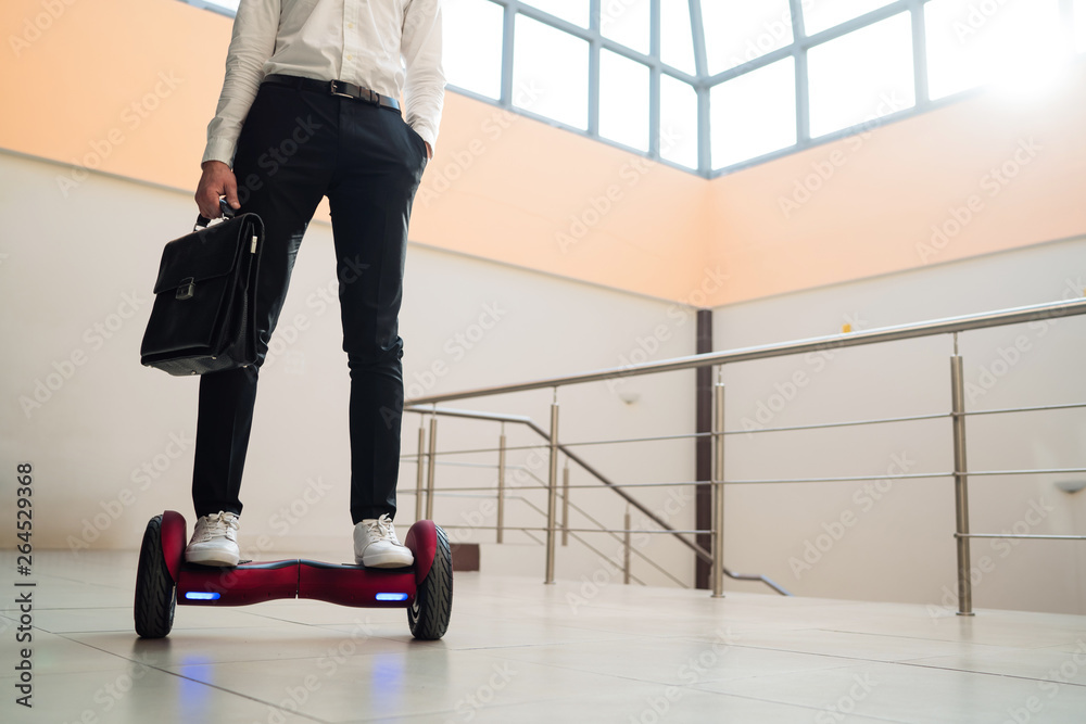 Young businessman is riding a gyroboard 