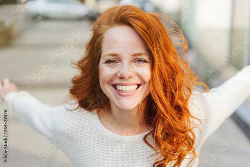 Happy impulsive young woman grinning at camera