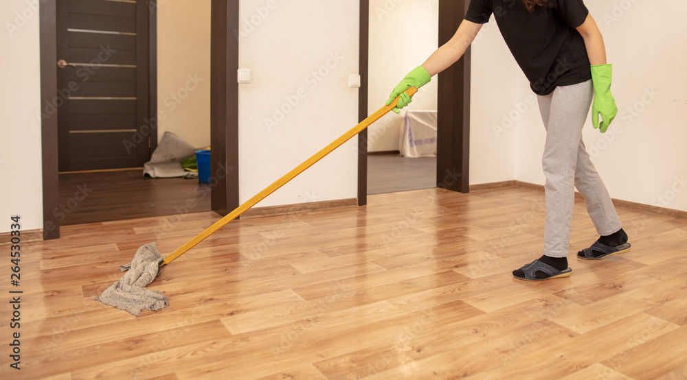 The girl washes the floor with a rag in the room The girl washes the floor with a rag in the room