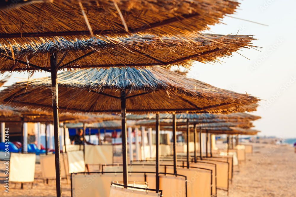 Fototapeta premium photos of reed beach umbrellas in perspective.