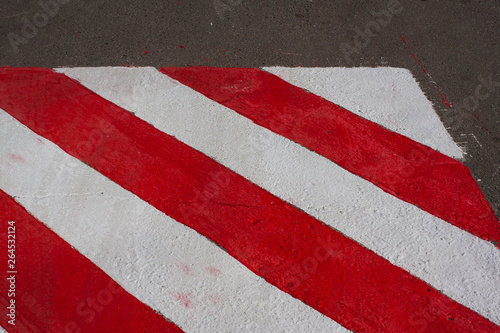 Texture. Painted on asphalt red white sign for special vehicles. Place for fire services and rescuers, emergency. No parking zone