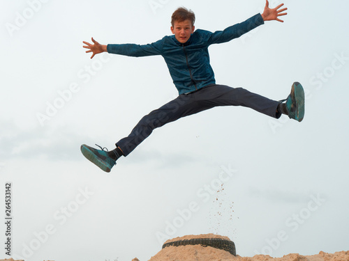 Bilde på lerret Children and teenagers have fun on the white sand. parkour
