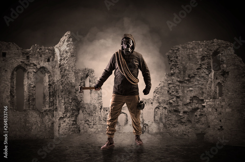 Hazard, menace man in a ruined crumbly building with arms on his hand
