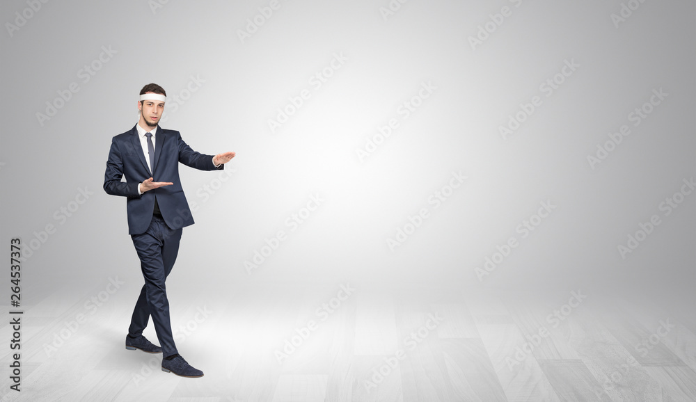 Young businessman in suit fighting in an empty space
Young businessman in suit fighting in an empty space