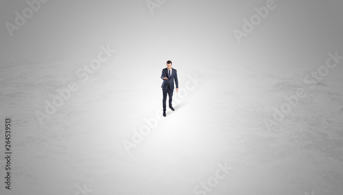 Young businessman standing alone in the middle of an empty space
