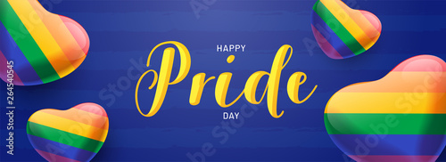 Happy Pride Day banner concept with glossy heartshapes in rainbow color on blue background.