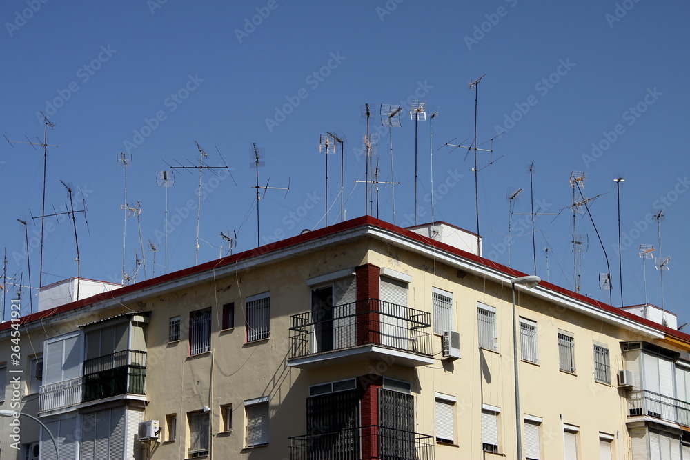 House with many roof-mounted television antennas in Seville
