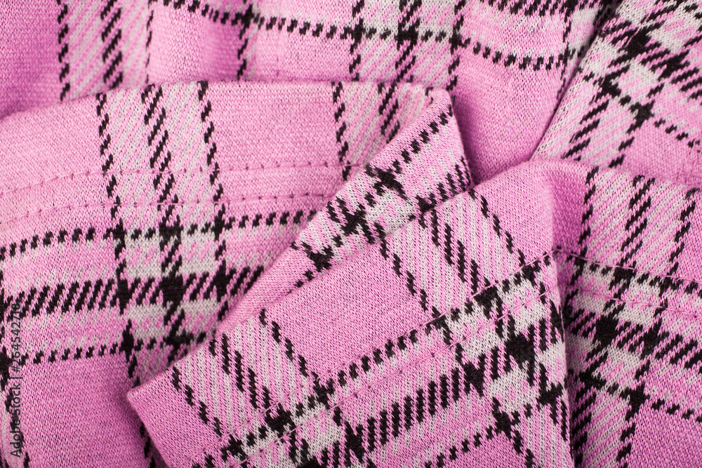 The crumpled texture of wool pink fabric in the cell