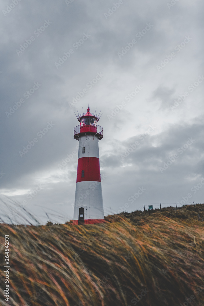 Lighthouse with clouds at the coast Lighthouse with clouds at the coast
