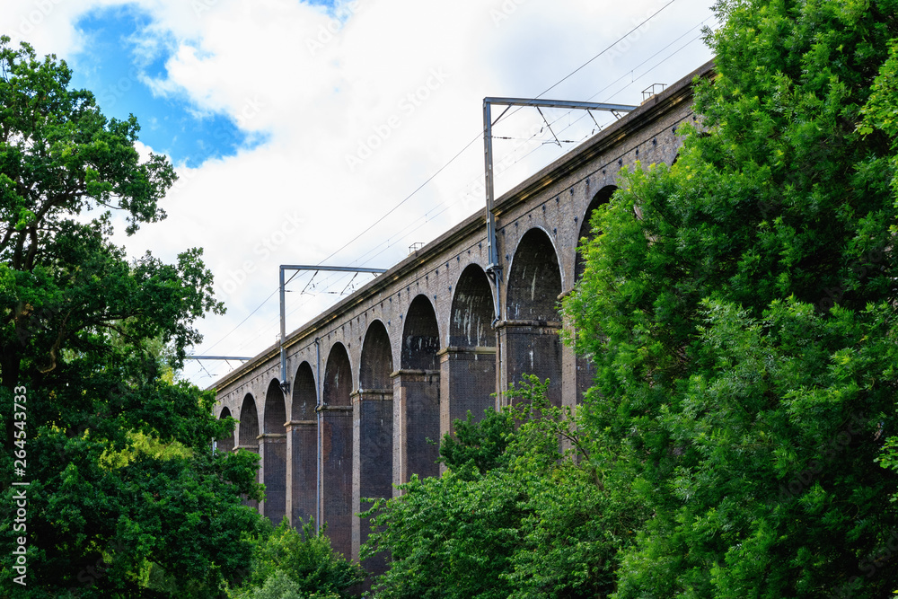 Digswell Viaduct (Welwyn Viaduct) with train in motion, located between Welwyn Garden City and Digswell in the UK