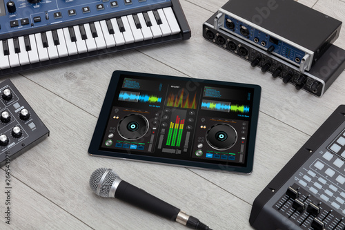 Mixing music on tablet with electronic music instruments concept 