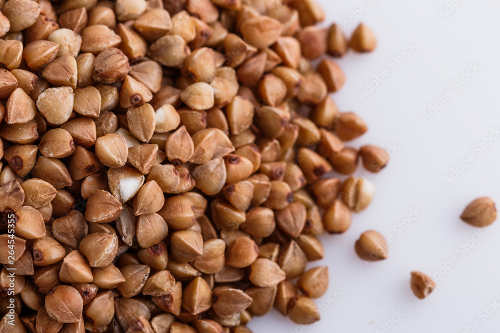 Grain buckwheat on a white acrylic background Grain buckwheat on a white acrylic background