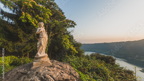 View of Lake Nemi and hills with statue on rock, from Nemi, Italy