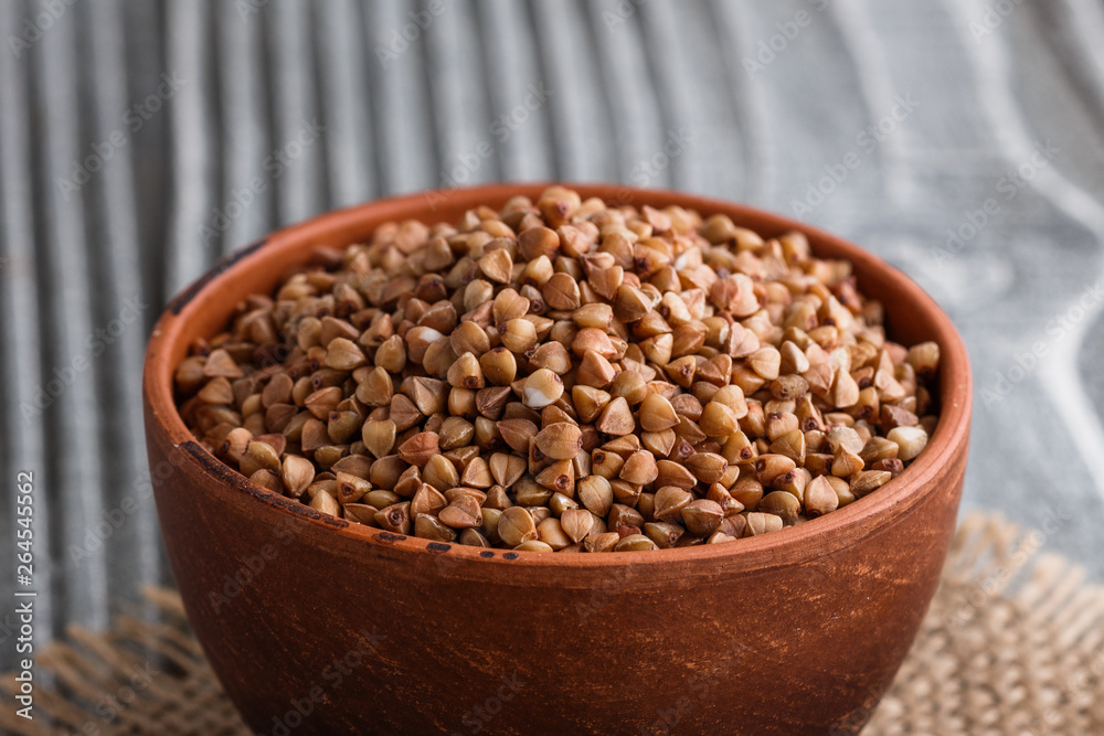 Grain buckwheat on a gray wooden background Grain buckwheat on a gray wooden background