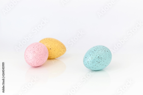 Three coloured easter eggs on white background