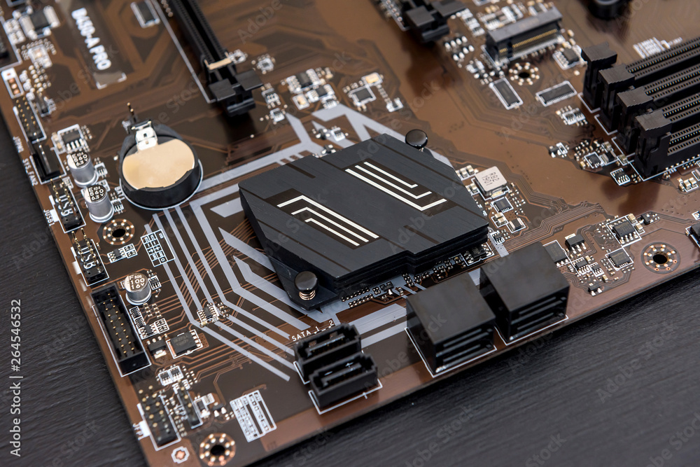 Computer motherboard on dark background, close up Computer motherboard on dark background, close up
