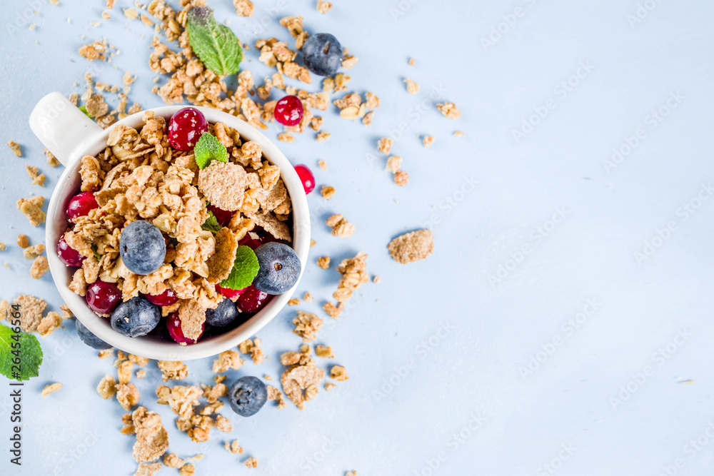 Small cup with breakfast granola, nuts and berries Small cup with breakfast granola, nuts and berries