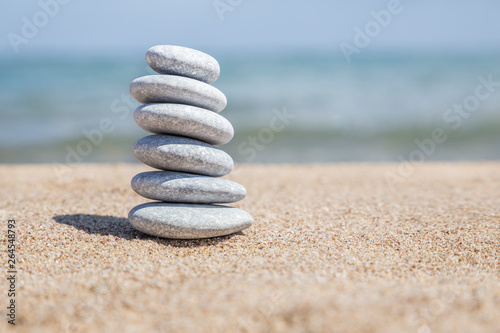 stack of pebble stones on balance on a sandy beach