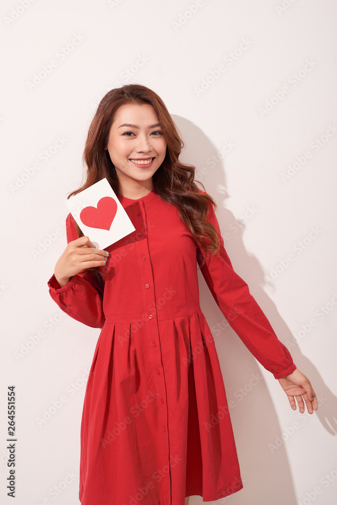 Portrait of happy romantic girl with red paper heart-shaped postcard, romantic wishes, Valentine day celebration, love concept Portrait of happy romantic girl with red paper heart-shaped postcard, romantic wishes, Valentine day celebration, love concept