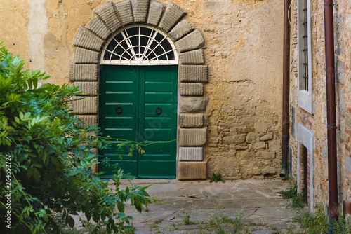 Very old door of the house in a Tuscan village.