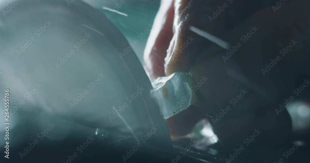 Slow motion close up of experienced goldsmith working on high quality aquamarine stones selected for making precious jewels in workshop. Shot in 8K. Concept of jewelry, luxury, goldsmith, diamonds