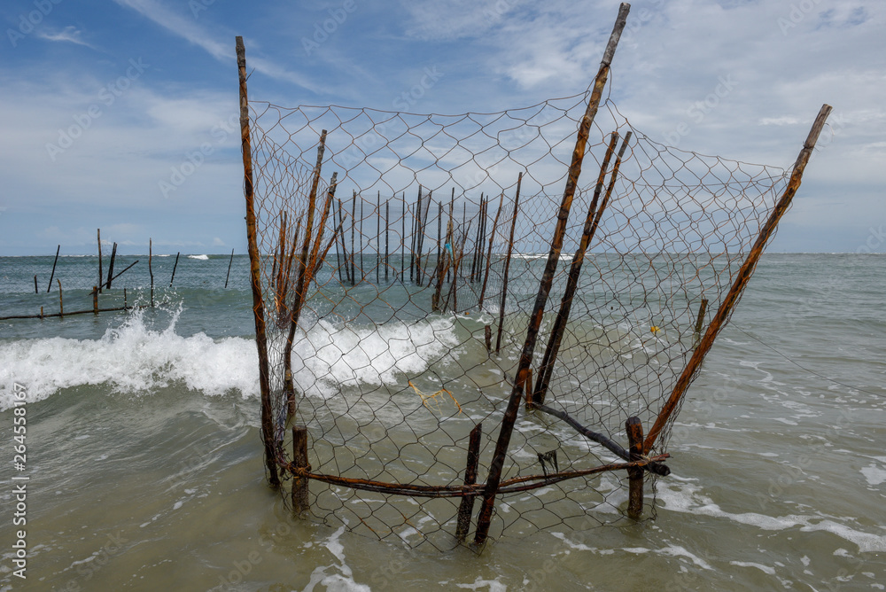 Wooden pole for stretch net fish trap from the beach into the sea