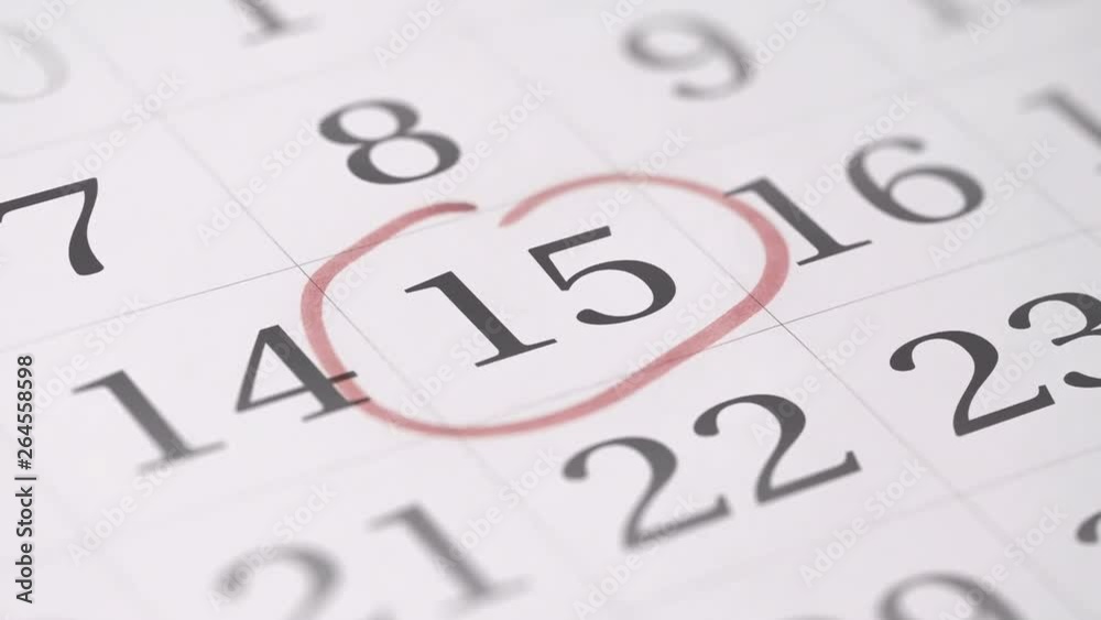 Marking the fifteenth 15 day of a month in the calendar with a red marker Marking the fifteenth 15 day of a month in the calendar with a red marker