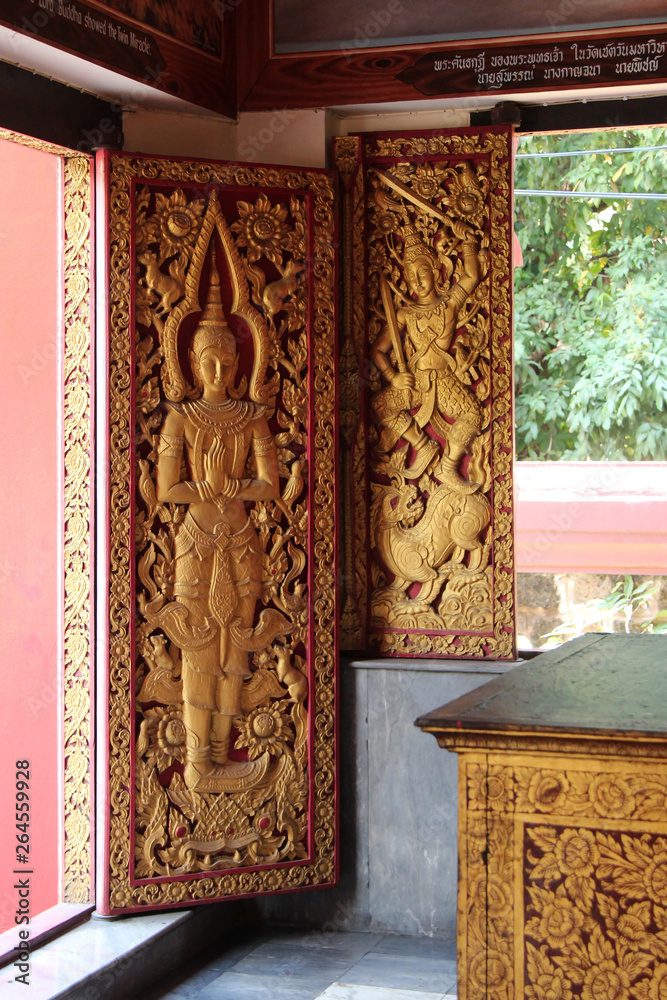 sculptured door and shutter in a buddhist temple (Wat Phan An) in chiang mai (thailand) 