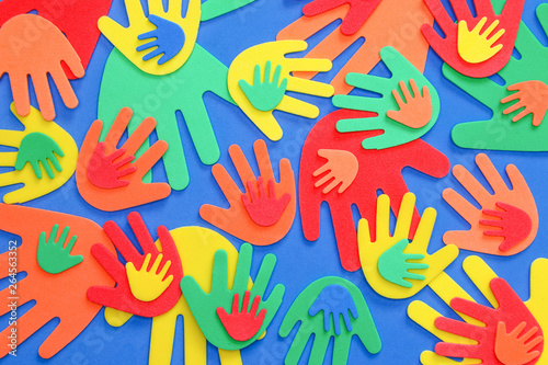Abstract background of funky foam hands cutouts of different sizes in red, orange, yellow, green and blue