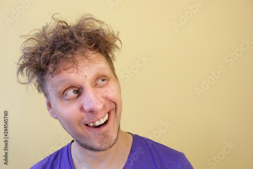 The man is smiling. Looking up. Light background.
