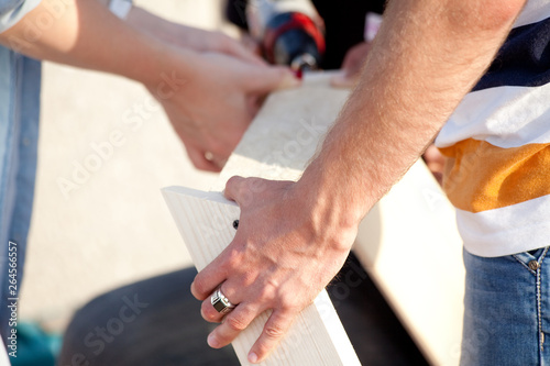 Carpentry. Hands holds wooden boards