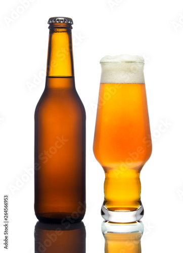 A glass of light beer and bottle on a white background, isolated