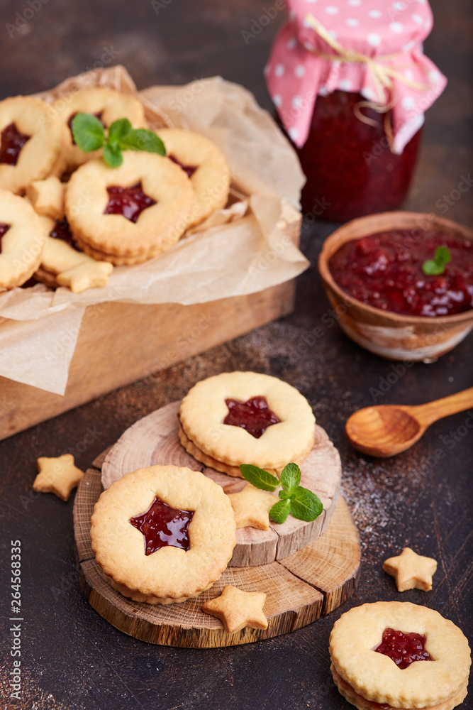 Linzer Christmas cookies with stars. Delicious biscuits with raspberry jam. Sweet dessert.