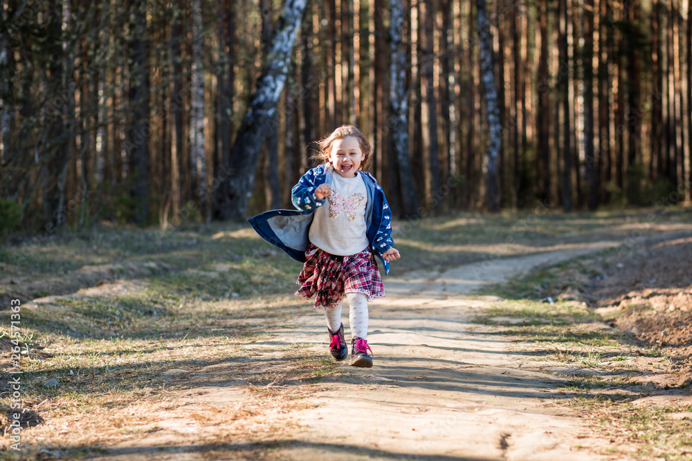 Fototapeta premium little girl in nature have fun and dance