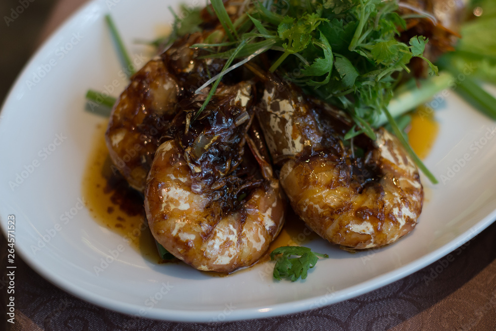 Seared King Prawns with Superior Soy Sauce and garnished with parsley on top Seared King Prawns with Superior Soy Sauce and garnished with parsley on top