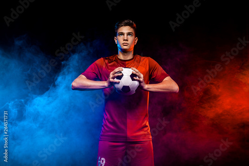 Teenager - soccer player. Boy in football sportswear after game with ball. Sport concept.