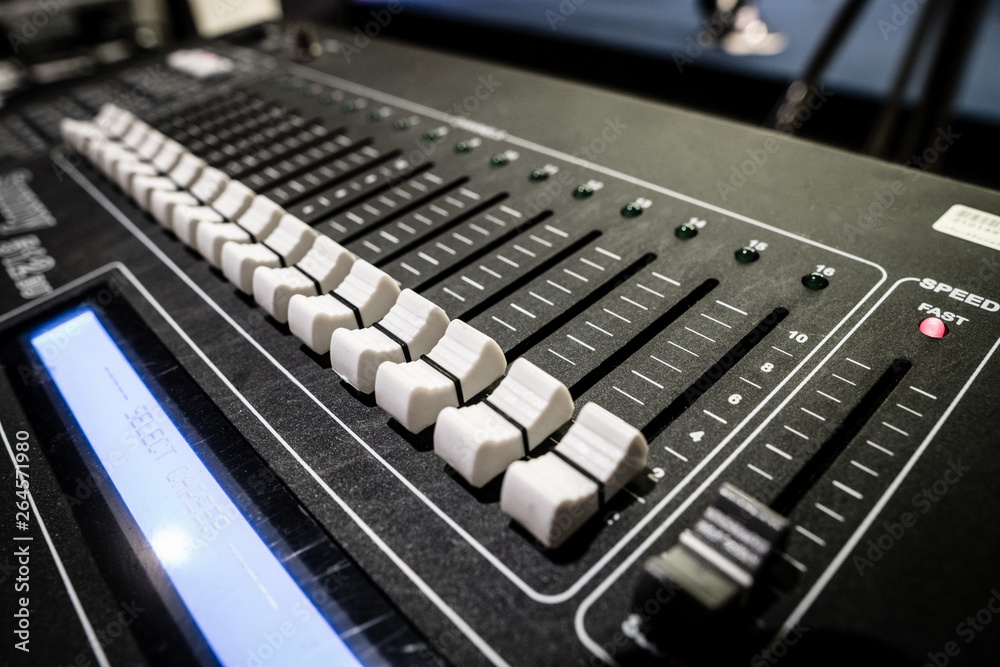 Sound Mixer Board with button to adjust detail of volume high low bar for MC DJ on stage and profession to speak in presentation and business purpose, close up soundboard equipment, blur some detail Sound Mixer Board with button to adjust detail of volume high low bar for MC DJ on stage and profession to speak in presentation and business purpose, close up soundboard equipment, blur some detail