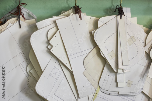 Wallpaper Mural Professional tailor paper template set hanging on the wall in the workshop. Manufacturing leather goods, craft products Torontodigital.ca