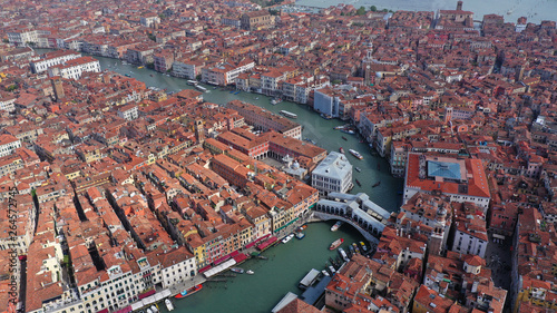 Aerial drone photo of iconic and unique Ponte Rialto or Rialto bridge crossing Grand Canal, Venice, Italy