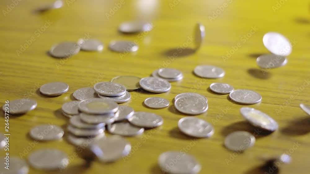 Slow Motion Close Up Large Pile Of Canadian Coins Falling Onto Wooden Table Slow Motion Close Up Large Pile Of Canadian Coins Falling Onto Wooden Table