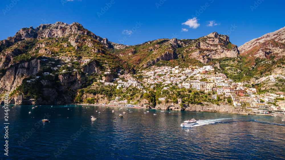 ship departs from the pier full tourist. Tourist Yacht Tour, water transport, traffic, license. rent vacation on the ship, boat. bay, beautiful sunny weather, vacation. aerial view Positano, Italy