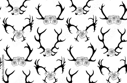 Seamless pattern with black silhouettes of deer and elk horns with flowers on white background. Vector texture for scrapbooking, wallpaper, textile and your design