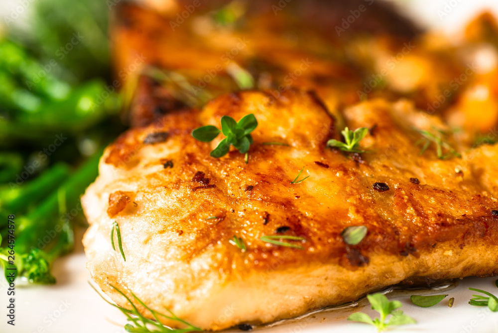 Detail of roasted carp with broccoli.