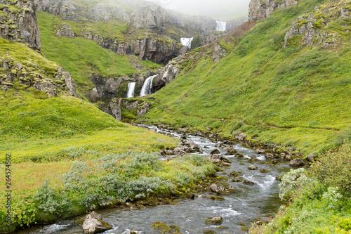 Klifbrekkufossar falls in summer season view, Iceland. photo