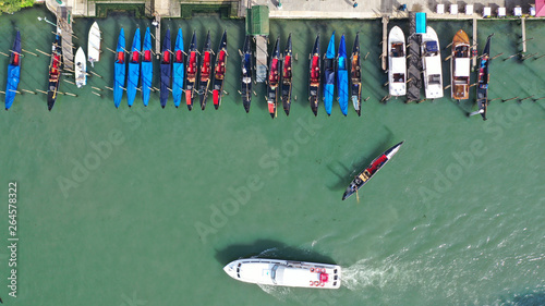 Aerial drone top view photo of iconic and unique colourful Gondolas in Grand Canal near Rialto bridge, Venice, Italy