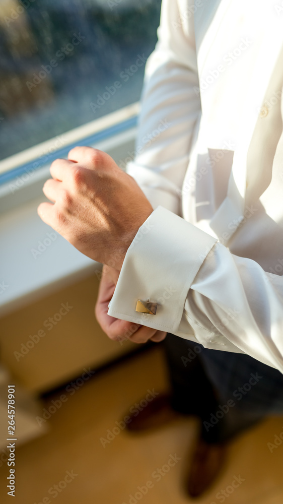 Fototapeta premium Groom wearing cufflink