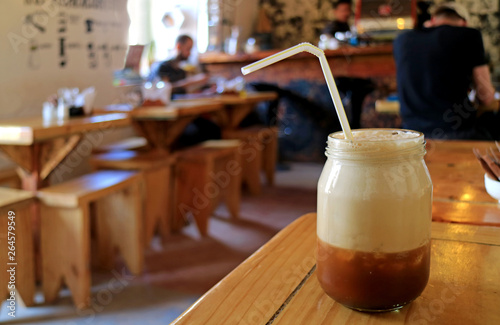 Iced cappuccino coffee on the cafe's wooden table