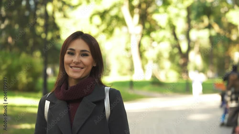 4k.Pretty smiling Asian woman in city park . Spring portrait 4k.Pretty smiling Asian woman in city park . Spring portrait